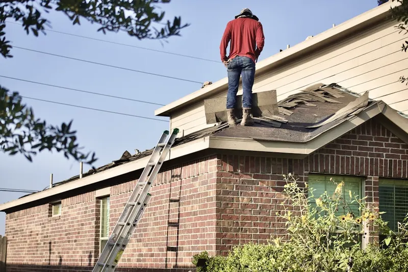 Professional roofer working on a residential roof in Wheaton Crest
